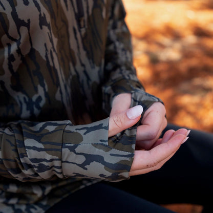 Close-up of women’s camo athleisure top showing thumb hole cuff and flexible performance fabric. 